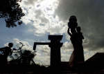 A woman carrying water pots at a well in the drought hit village of Hura. Photo: Reuters/Jayanta Shaw 