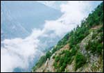 The road to Roghi,  the old Hindustan Tibet highway. Its curving bends
are matched only by the swirling clouds around